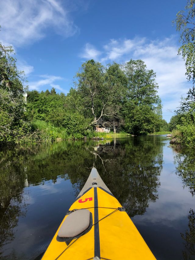 Experience tranquil kayaking on a picturesque lake surrounded by lush greenery.